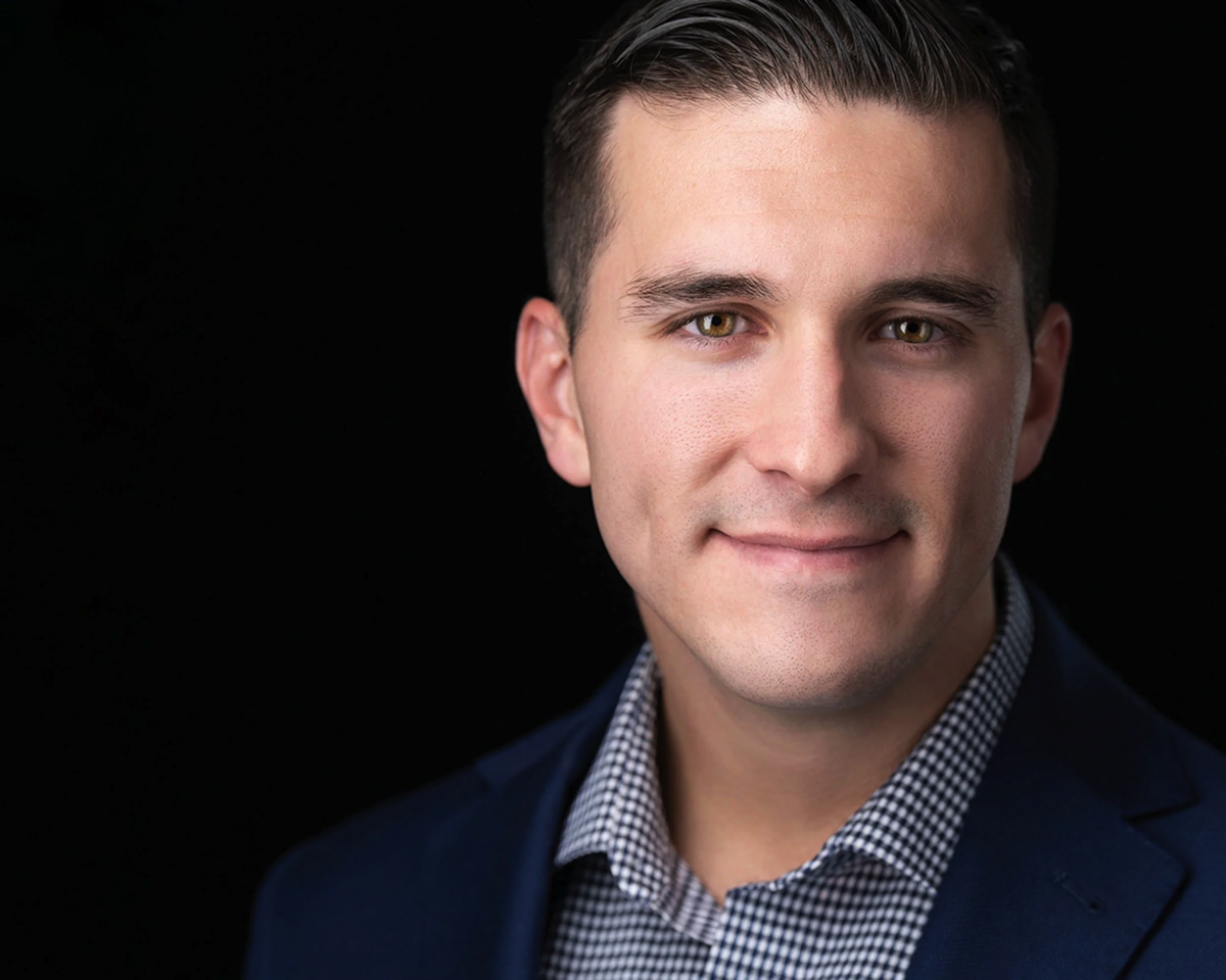 Man in a Checkered Shirt and Blue Jacket